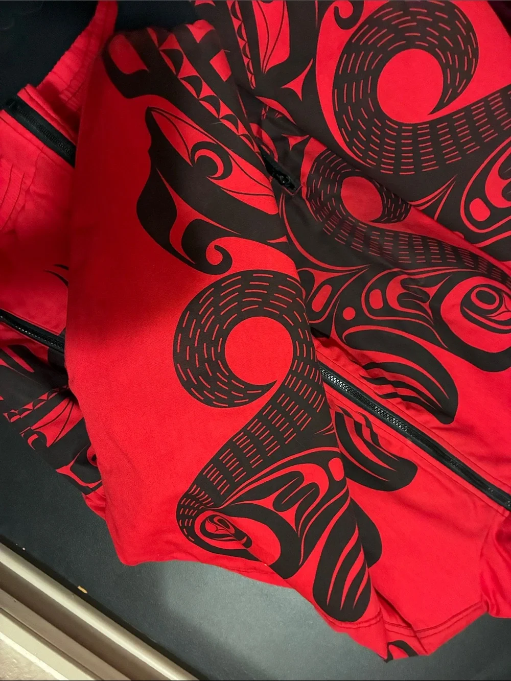 Red Puffer Jacket with Black Graphic Detailing